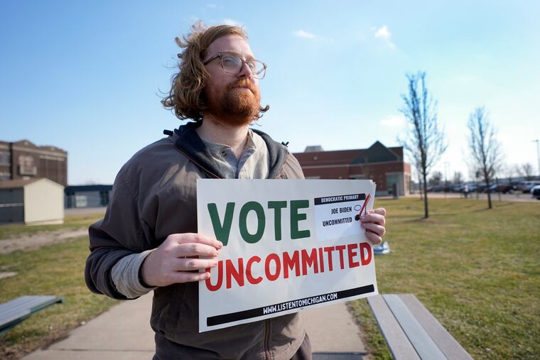 Eric Suter-Bull holds a Vote Uncommitted sign outside a voting location in Dearborn, Mich., for the Michigan primary election on Feb. 27. An effort to get Democrats to vote uncommitted in Michigan has inspired a larger initiative that includes Pennsylvania.
