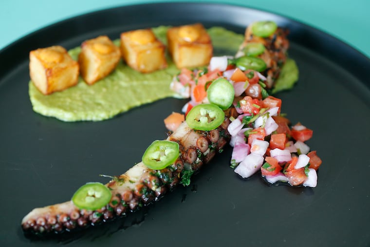 Octopus a la parilla with crispy potatoes, avocado mousse, pico de gallo, and jalapeños served at Izlas Latin Cuisine.