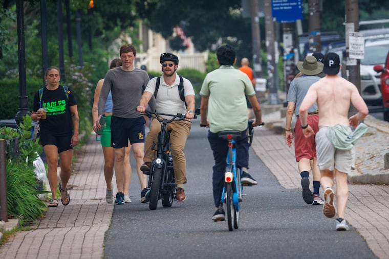 Runners, walkers and cyclists along Kelly Drive on a steamy Thursday morning.