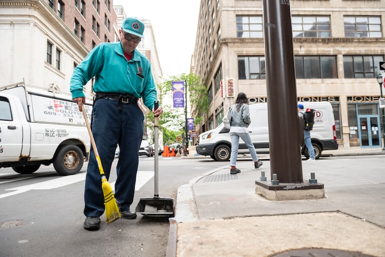Tom Fitzmaurice sweeps up trash on Seventh and Chestnut Streets on his street sweeping route on April 29.