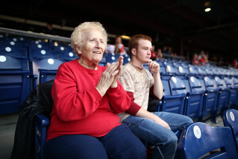 Starting her 40th season, Jane Sorendino takes in a preseason Phils game at Citizens Bank Park with grandnephew Tyler Dimter.