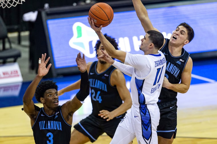 Creighton star guard Marcus Zegarowski (11) makes a layup in front of Villanova's Brandon Slater (3), Jeremiah Robinson-Earl (24), and Collin Gillespie (2) during the second half.