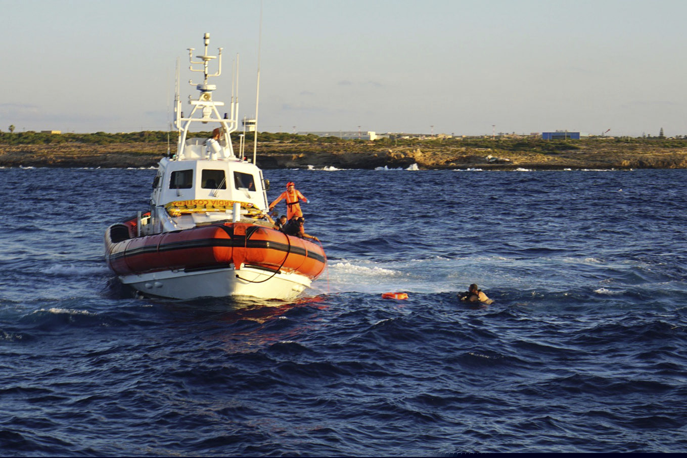 A man who threw himself in the water from the Open Arms vessel, is intercepted by the Italian Coast guards as he tried to swim to the island of Lampedusa, southern Italy, Tuesday, Aug. 20, 2019. The Spanish humanitarian rescue ship Open Arms says another man had to be rescued after jumping in the sea as the stand-off with Italy, which won't permit it access to a port, entered its 19th day. Open Arms described the situation on board Tuesday as ''desperate,'' saying that a man threw himself in the water trying to reach trying to reach land in plain view, while at the same moment a woman suffered a panic attack.