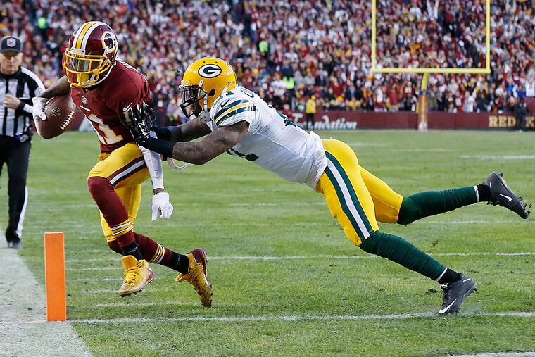 Washington Redskins wide receiver DeSean Jackson (11) carries the ball for a touchdown but the play was reversed upon replay review in front of Green Bay Packers free safety Ha Ha Clinton-Dix (21) during the first half in a NFC Wild Card playoff football game at FedEx Field.