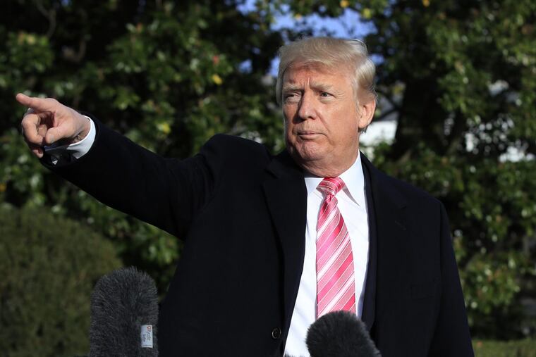 President Donald Trump points to reporters as he leaves a news conference at the White House, Tuesday, Nov. 21, 2017, in Washington.