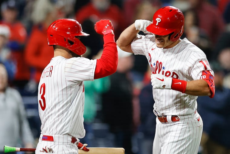 Phillies J.T. Realmuto celebrates his eighth inning two-run home run with teammate Bryce Harper against the New York Mets on Monday, April 11, 2022 in Philadelphia.