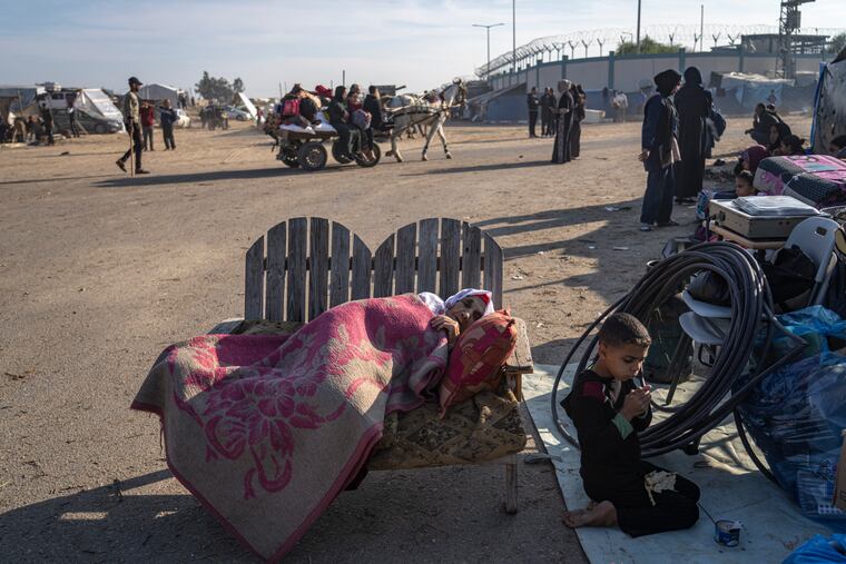 Palestinians displaced by the Israeli bombardment of the Gaza Strip gather at a tent camp, in Rafah, southern Gaza strip, on Monday.
