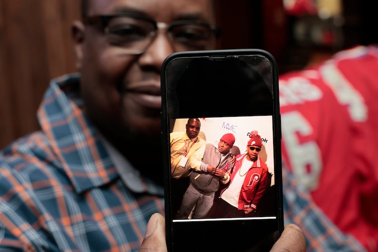 TGI Fridays manager Tim Hampton displays an early 2000s photo of himself and Allen Iverson at the City Avenue restaurant.