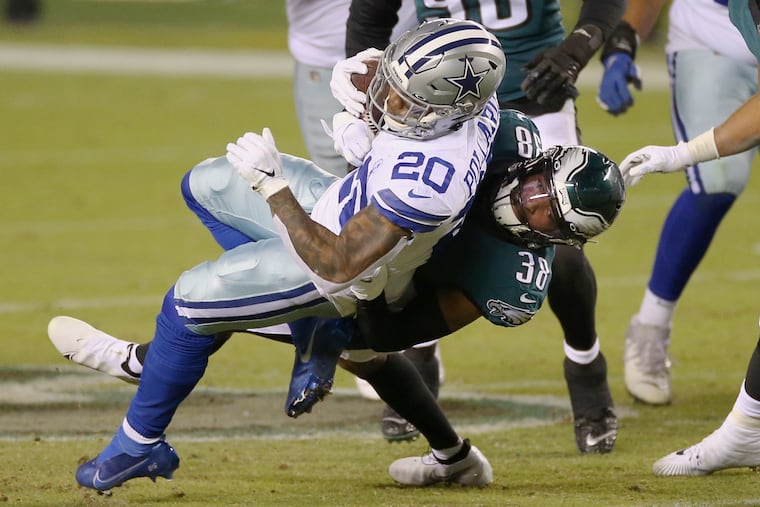 Eagles cornerback Michael Jacquet tackles Cowboys running back Tony Pollard last Sunday.