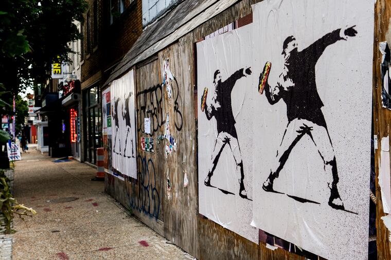 Posters of a person throwing a sandwich are pictured along H Street in Washington.