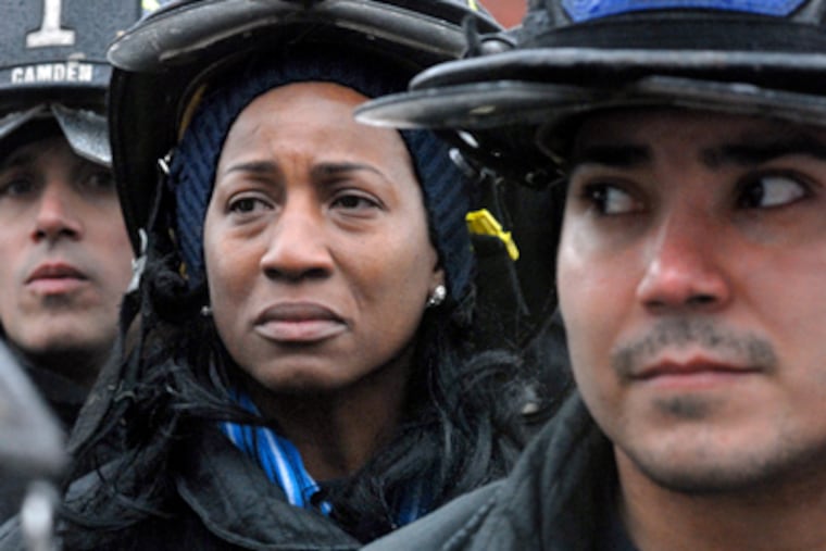 Renee Muhammad and other laid-off firefighters wait to turn in gear. She was one of the first women on the job in Camden. (April Saul / Staff Photographer)