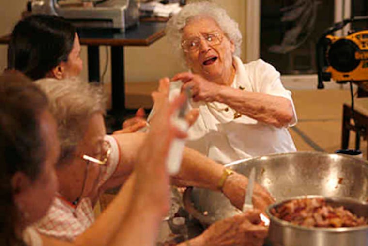 The first Thursday of August means one thing in Downingtown's old Italian neighborhood - the Amphibious Order of Frogs dinner. Here, Laurie Mascherino Reutter leads the group in belting out "Sweet Caroline." (Charles Fox / Staff )
