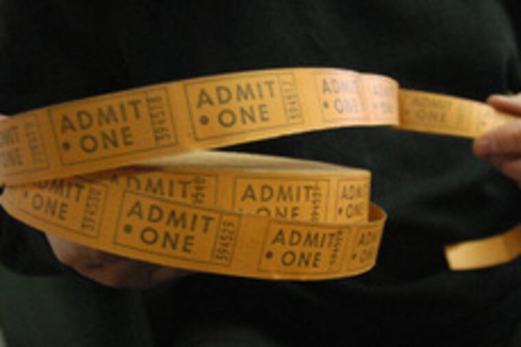 Bob Langmuir holds a roll of tickets to Hubert's Dime Museum.