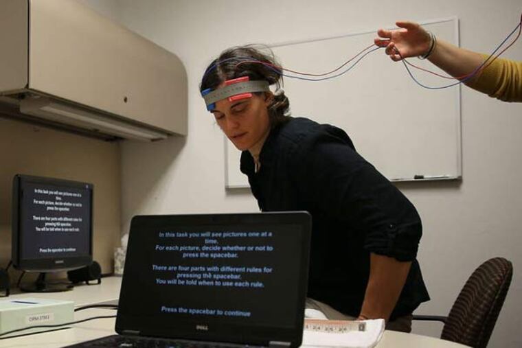 The transcranial direct current brain stimulation test developed by Penn researcher Caryn Lerman is demonstrated by Becky Ashare.