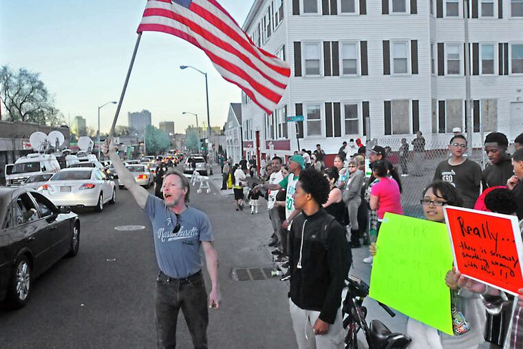 Protesters gather outside the funeral home housing the body of bombing suspect Tamerlan Tsarnaev.