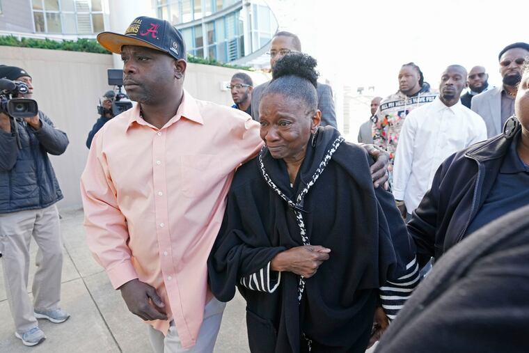 Eddie Terrell Parker, left, escorts Mary Jenkins, mother of Michael Corey Jenkins, into the Thad Cochran United States Courthouse in Jackson, Miss., on Tuesday, for sentencing on two of the six former Mississippi Rankin County law enforcement officers who committed numerous acts of racially motivated, violent torture on Parker and his friend Jenkins in 2023.
