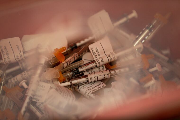Disposed COVID-19 vaccine syringes sit in a container at the “Vaccine Clinic” inside the Virtua Barry D. Brown Health Education Center in Voorhees, N.J. on December 29, 2020.
