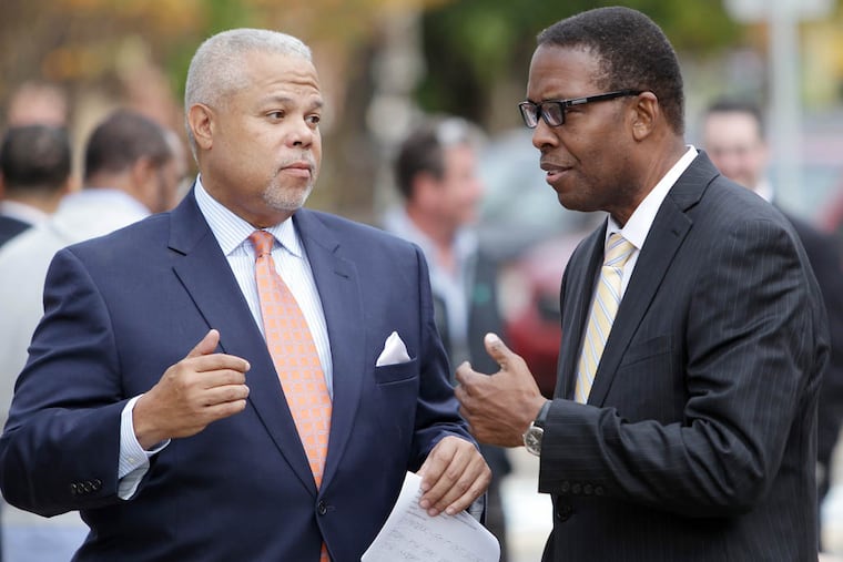 State Sen. Anthony Hardy Williams, left, and Council president Darrell Clarke talk outside Famous 4th Street Deli on November 4, 2014. ( DAVID MAIALETTI / Staff Photographer )