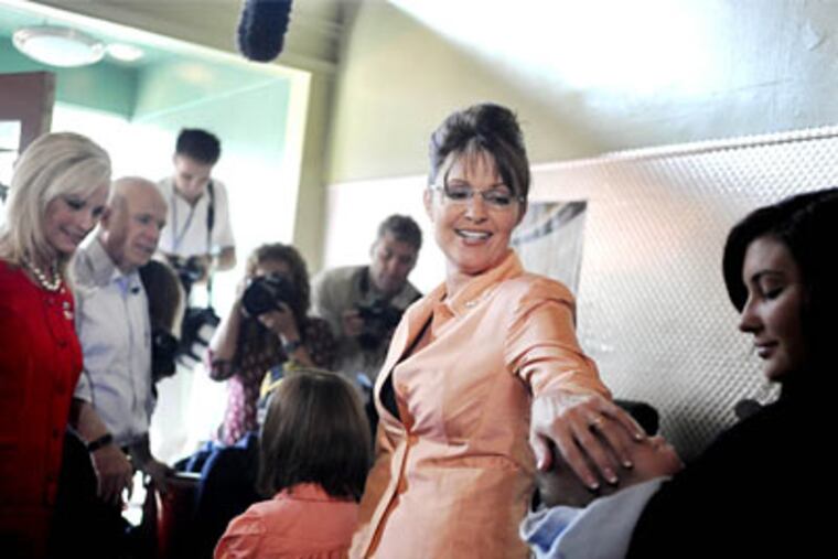 Senator John McCain makes an early morning campaign stop at Tom's Diner in the Southside with his wife Cindy and running mate Governor Sarah Palin on Saturday, Aug. 30, 2008. (Michael Henninger / Post-Gazette)