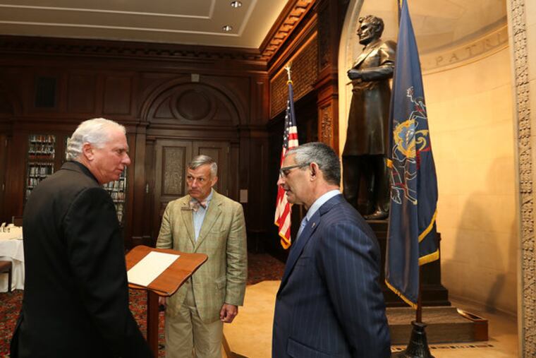 Around Lincoln’s lectern, Fred Stein (left) of the Creative Group and Bob Ciarruffoli (right) of
World Meeting of Families 2015 talk with James Mundy of the Union League, where the historic
piece is being kept while on loan. (DAVID MAIALETTI / Staff Photographer)
