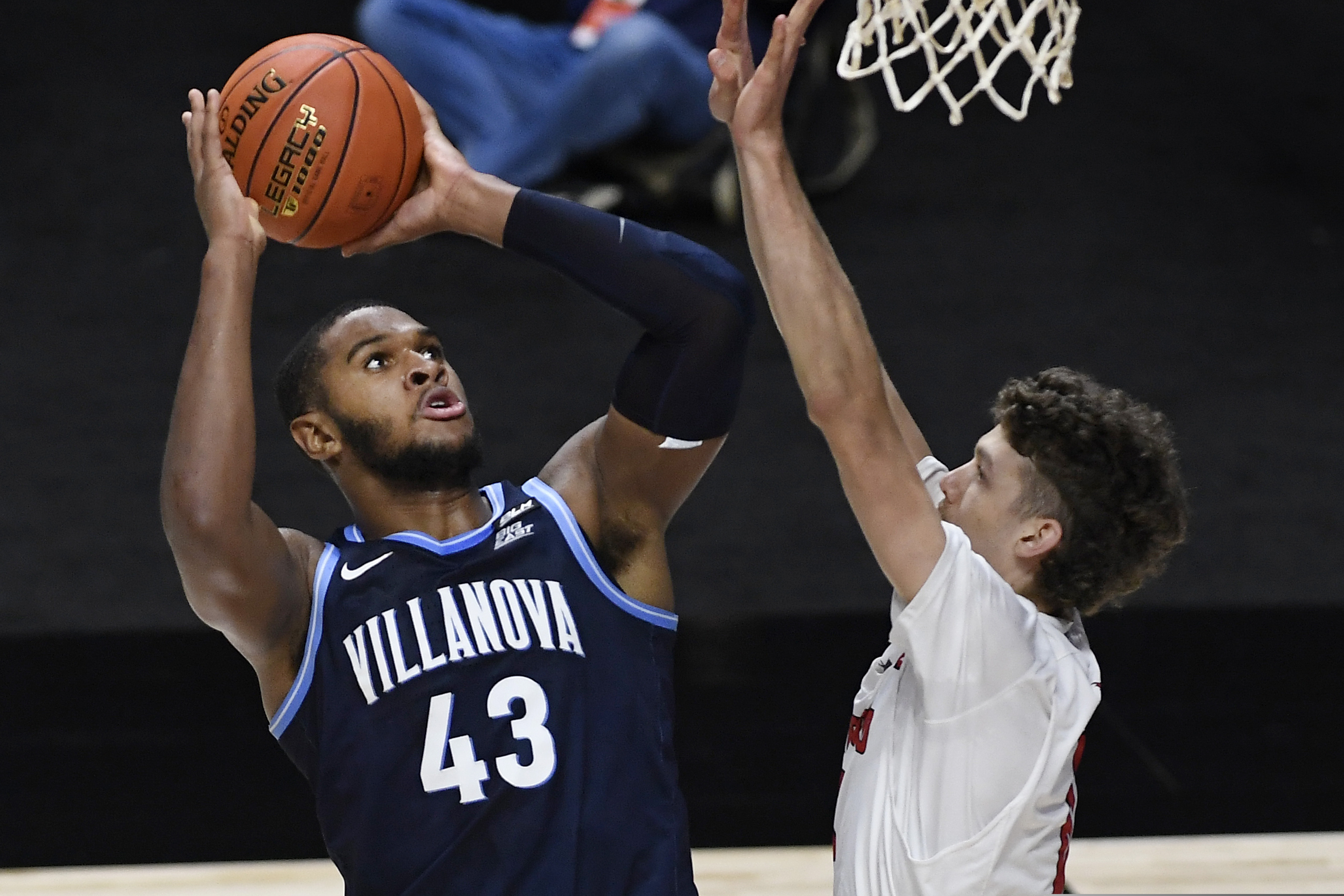 Villanova's Eric Dixon shoots over Hartford's Hunter Marks in the first half Tuesday in Uncasville, Conn.