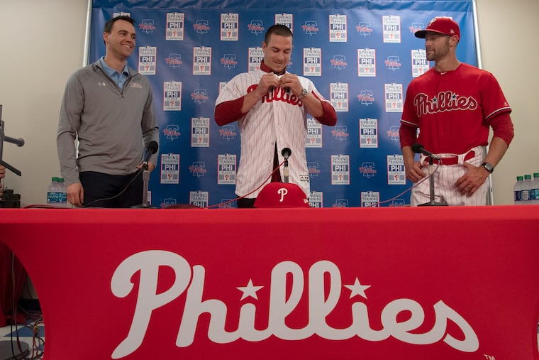 Philadelphia Phillies general manager Matt Klentak (left), catcher J.T. Realmuto (center), and manager Gabe Kapler smile during a news conference Tuesday.