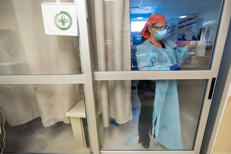 Nurse Sherry Seymour treats a COVID-19 patient at Suburban Community Hospital in Norristown, PA, in 2021.