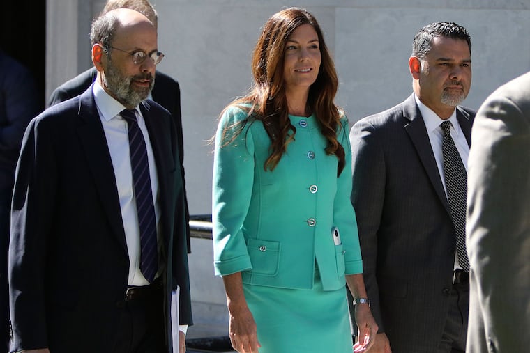 Attorney General Kathleen Kane and her legal team exits court after attending a pretrial hearing in Norristown.