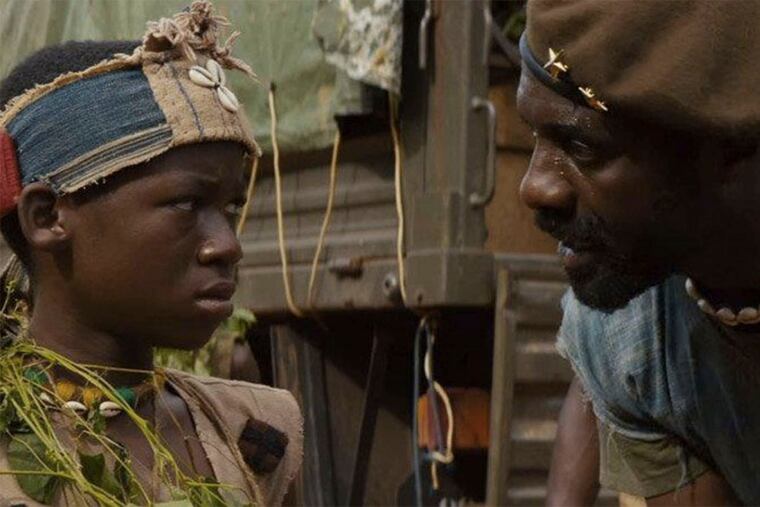 Idris Elba (right) plays a military leader who uses his charisma to draw young boys into the world of murderous soldiering.