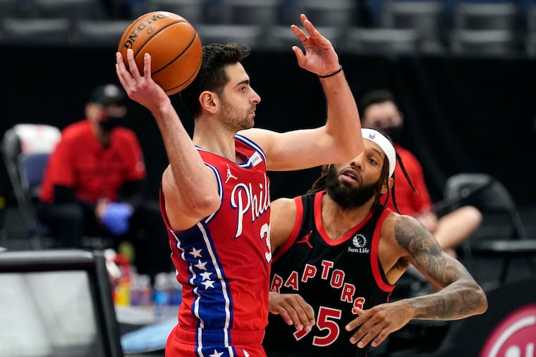 Sixers guard Furkan Korkmaz looks to pass in front of Toronto Raptors forward DeAndre' Bembry (95) during the second half.