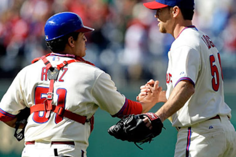 Brad Lidge celebrates with catcher Carlos Ruiz after the final out of the Phillies' 5-3 win over the Braves. (David Maialetti / Staff Photographer)