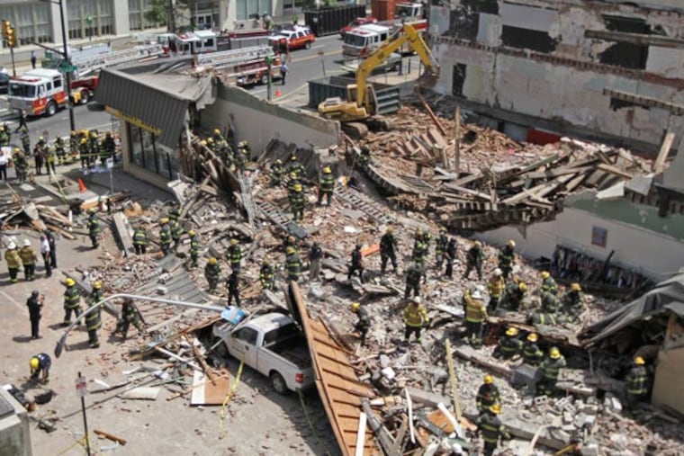 An overhead shot of the scene of the building collapse at 22nd and Market Street. An apartment building that was being torn down collapsed onto a one-story Salvation Army thrift store. Here, fire and police go through the rubble looking for survivors. ( MICHAEL BRYANT / Staff Photographer )