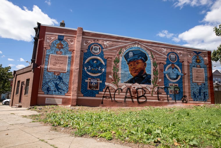 A mural honoring slain officer Sergeant Robert Wilson III by artist David McShane was vandalized in West Philadelphia Sunday.