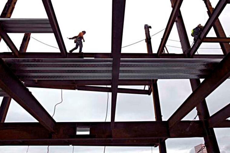 FILE - In this Nov. 29, 2014 file photo, steelworker Nik Pries of Refa Erection walks across decking 23 stories above ground as construction continues on the new Park Avenue West Tower in downtown Portland, Ore. Six years after its financial system nearly sank and nearly that long since the recession ended, the United States seems poised to grow in 2015 at its fastest pace in a decade. Its growth from July through September _ a 5 percent annual rate _ was the swiftest for any quarter since 2003. (AP Photo/The Oregonian, Kristyna Wentz-Graff, File)