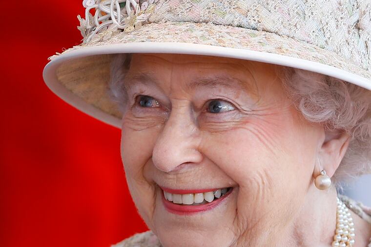 Britain's Queen Elizabeth II smiles as she awaits the arrival of the President of the United Arab Emirates Sheik Khalifa bin Zayed Al Nahyan in Windsor in England, Tuesday, April 30, 2013.