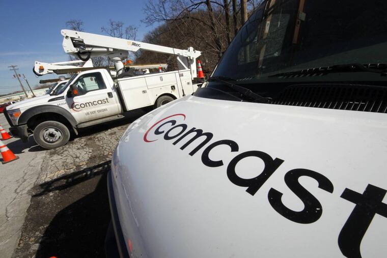 FILE - This Feb. 15, 2011 file photo shows Comcast installation trucks in Pittsburgh. Comcast Corp. reports quarterly financial results before the market opens Tuesday, July 22, 2014. (AP Photo/Gene J. Puskar, File)