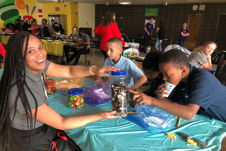 Raijene Dreuitt works with students during a math and literacy competition in April as a member of the City Year Philadelphia AmeriCorps program.