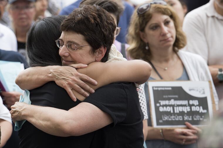 Blanca Pacheco, the assistant director of the New Sanctuary Movement, left, is embraced by Maggie Trotzky, during an immigration protest outside of the United States Custom House on 200 Chestnut St, in Philadelphia.