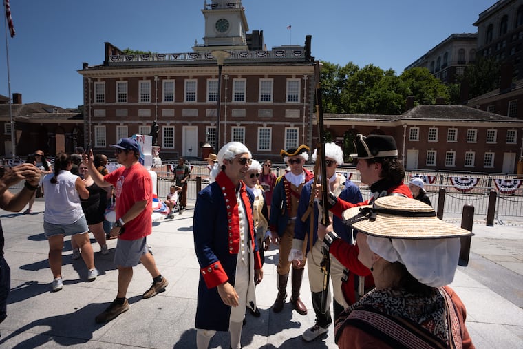 Libby the Liberty Bell and visitors dressed in colonial costumes in front of Independence Hall, in Philadelphia, July 4, 2026.