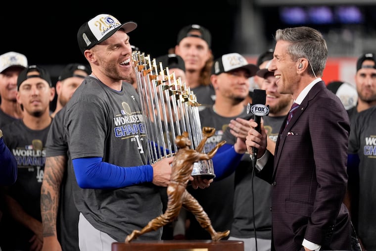 Freddie Freeman of the Dodgers celebrates with the MVP trophy after Los Angeles finished off the Yankees in Game 5 to win the World Series.