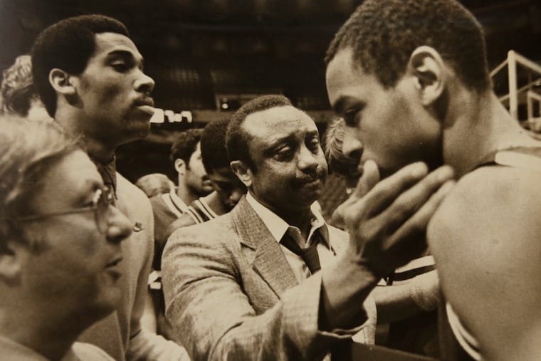 John Chaney, center, embraces Terence Stansbury, who was a third-team All-America honoree by the National Association of Basketball Coaches in 1984 and Chaney's first great player at Temple.