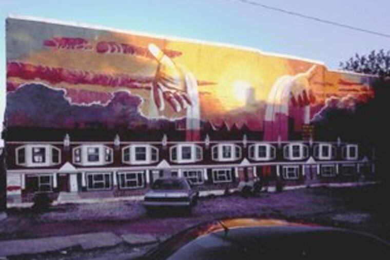 Ras Malik's neighborhood mural titled "Compassion," at 55th and Regent Streets in West Philadelphia. He has called the 1997 work his own favorite among his Philadelphia murals.