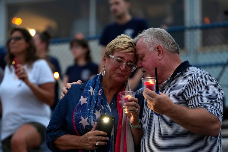 People embrace during a vigil for Corey Comperatore, the former fire chief shot and killed at a weekend rally for former President Donald Trump, at Lernerville Speedway in Sarver, Pa.