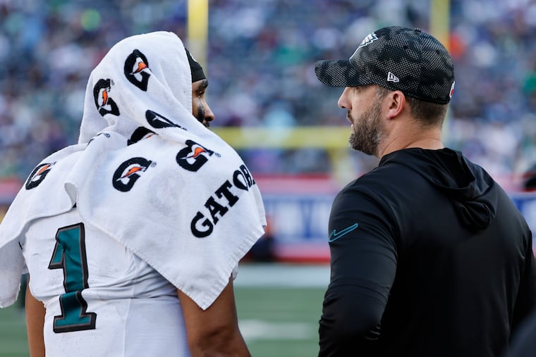 Eagles coach Nick Sirianni talks with quarterback Jalen Hurts during the fourth quarter of the game against the Giants on Oct. 20.