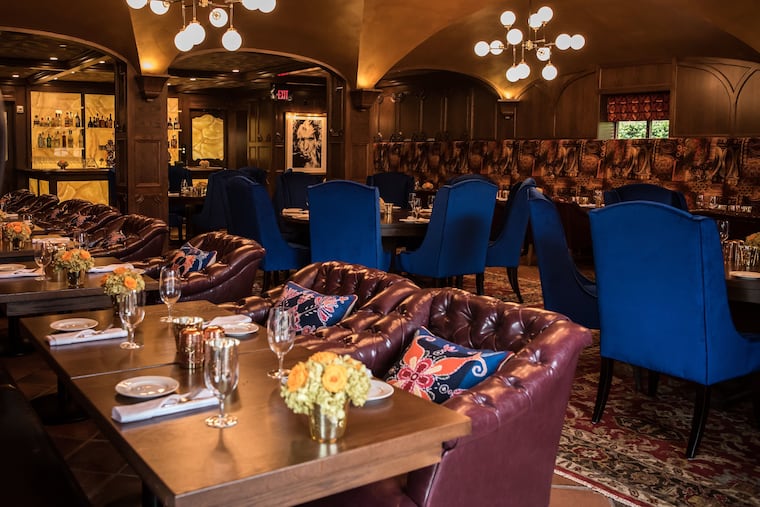 The blue velvet dining room chairs and pillow accents in Wayne's Autograph Brasserie happen to be the 2020 color of the year, Classic Blue.