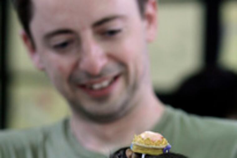 Dan Kelly admires one of his pageant winners at the annual South Philadelphia event.