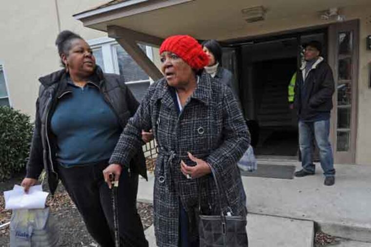 An apartment fire kills one resident at the Keystone Apartments at 32 South Wycombe Avenue in Lansdowne. Here, Betty Wade, who was staying at the apartments, leaves the building with an assist from her daughter, who is also named Betty Wade. ( APRIL SAUL / Staff Photographer )