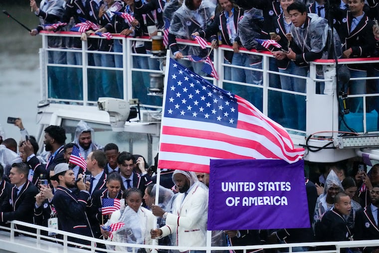 United States' Coco Gauff and Lebron James (bottom) travel with teammates along the Seine River in Paris, France, during the opening ceremony.