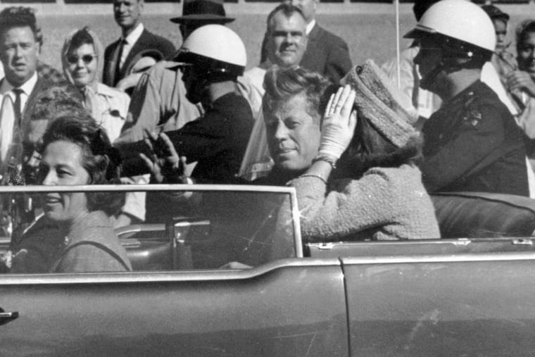 President John F. Kennedy waves from his car in a motorcade approximately one minute before he was shot in Dallas on Nov. 22, 1963.