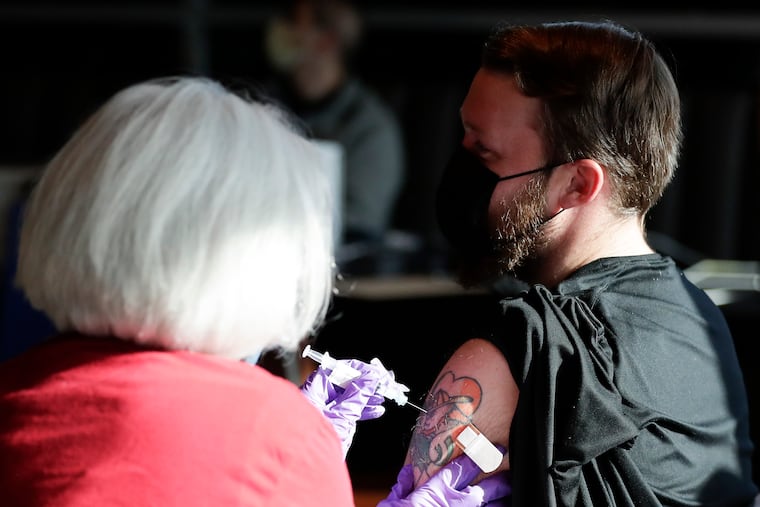 Ryan DiFilipo, a member of the Flyers Ice Crew, receives the Johnson & Johnson COVID-19 vaccine from Penn Medicine Nurse Practitioner Erin McMenamin before the Flyers play the New Jersey Devils on May 10.